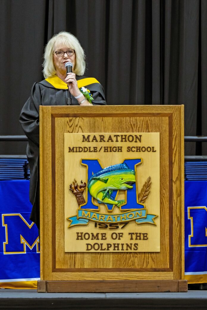 a woman standing at a podium with a microphone