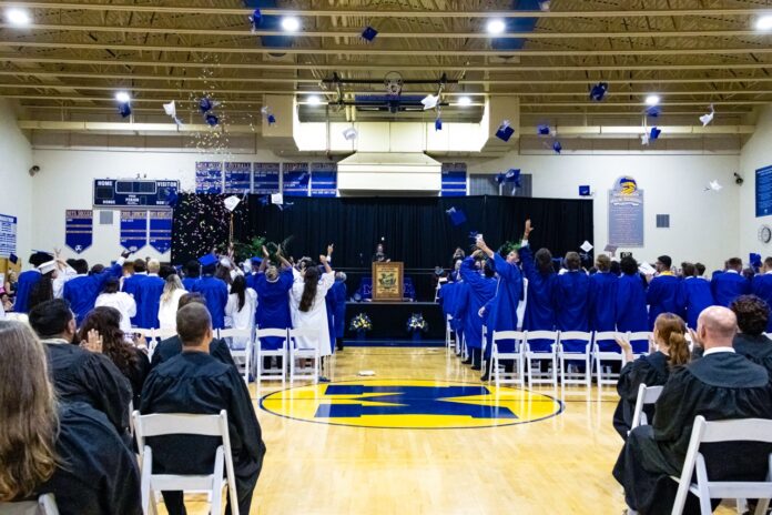 a group of people sitting in chairs in a gym