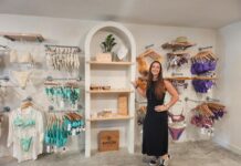 a woman standing in front of a display of jewelry