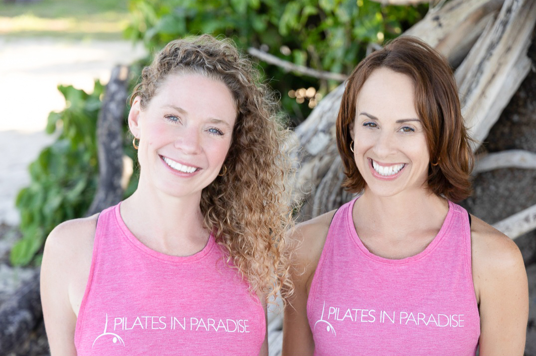 two women in pink shirts standing next to each other