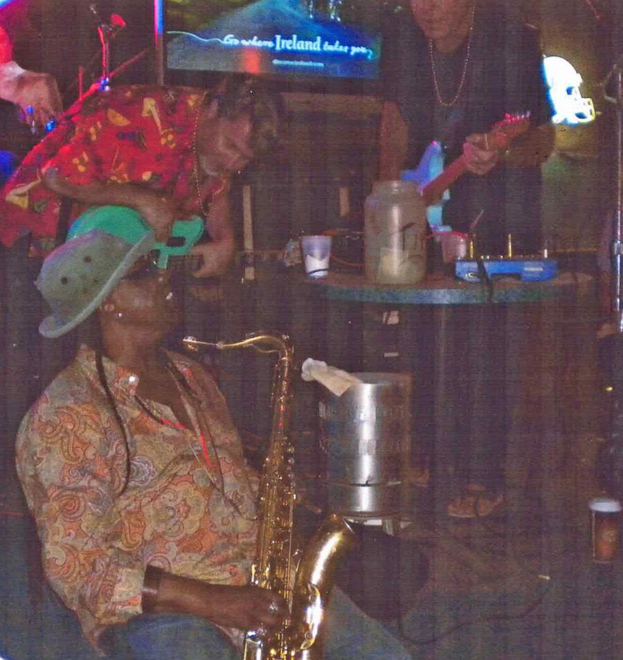a group of people playing instruments in a bar