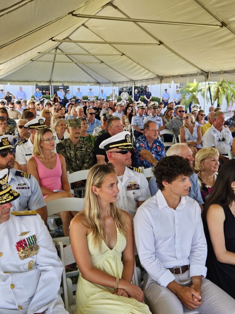 a large group of people sitting under a tent