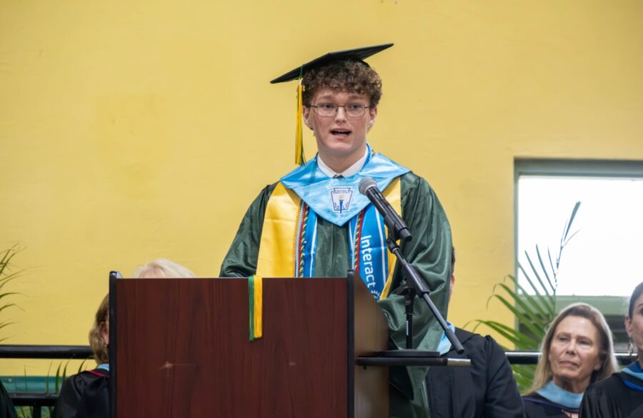 a man standing at a podium with a microphone