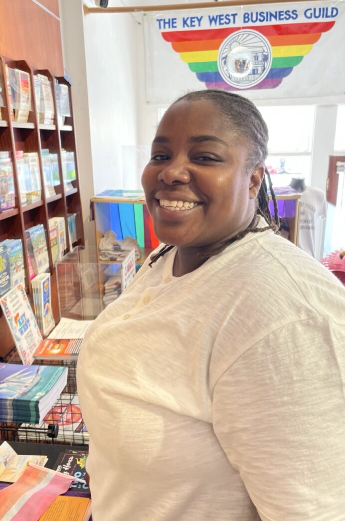 a woman standing in front of a book shelf