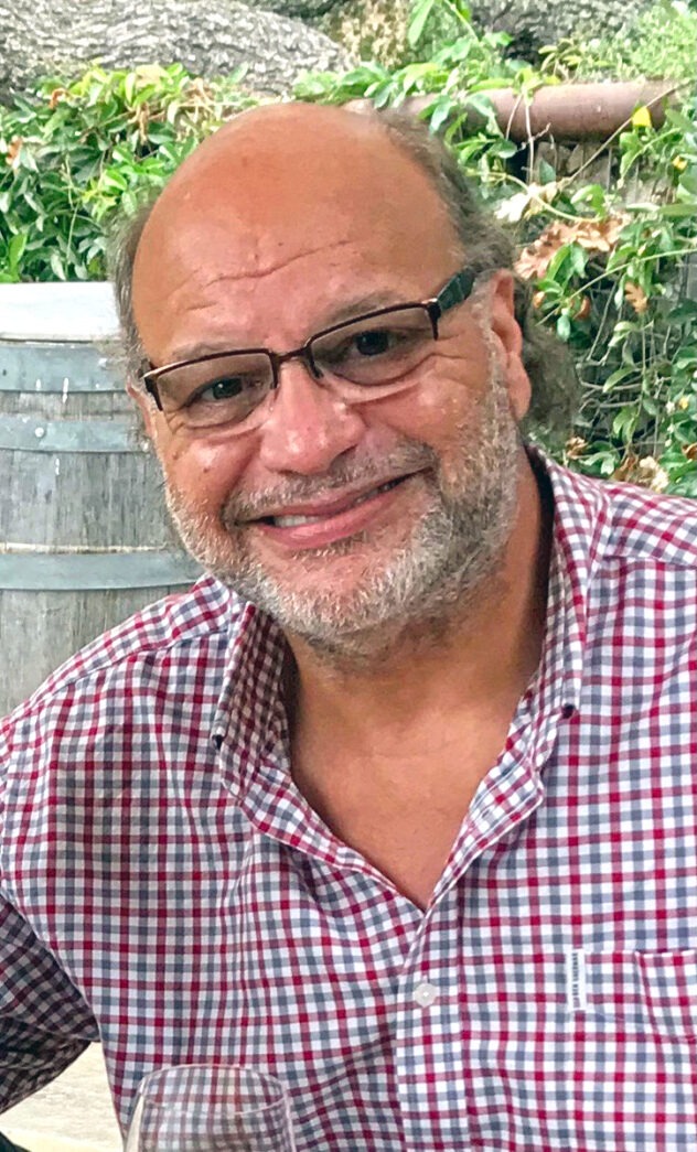 a man with glasses sitting at a table