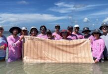 a group of people standing in the water