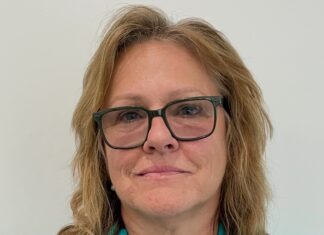a woman wearing glasses and a blue shirt