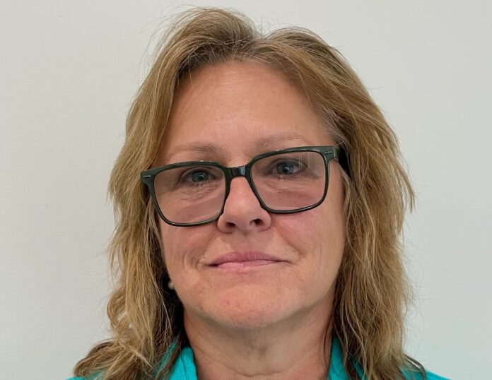 a woman wearing glasses and a blue shirt