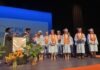 a group of people standing on top of a stage