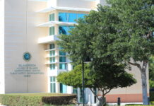 a white building with a tree in front of it