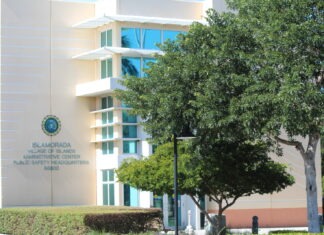 a white building with a tree in front of it