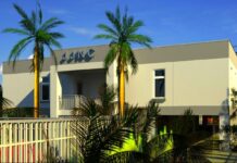 a building with palm trees in front of it