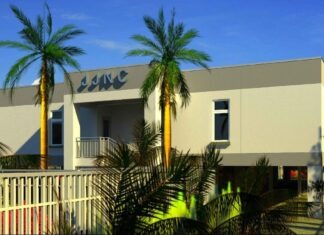 KEY WEST OFFICIALS TO OPEN NEW HOMELESS SHELTER a building with palm trees in front of it