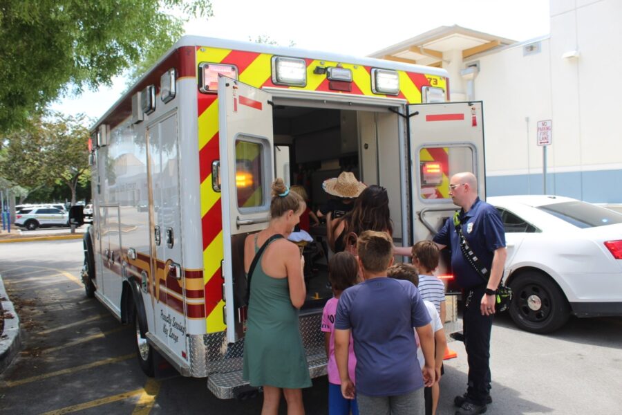 a group of people standing in front of a fire truck
