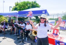 a woman standing in front of a table with a flag on it