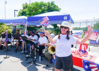 a woman standing in front of a table with a flag on it