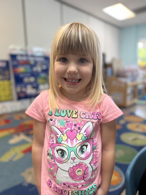 a little girl that is standing in a room
