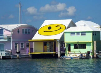 a row of houses with a smiley face painted on the roof