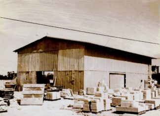 a black and white photo of a building with boxes in front of it