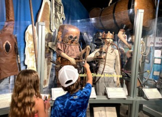 a boy and girl looking at a display of costumes