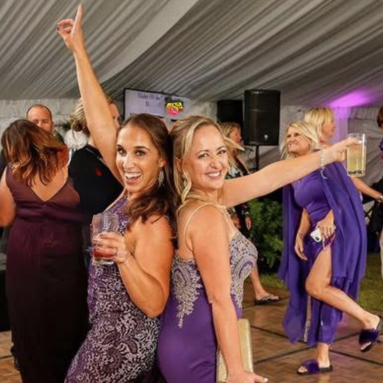 a couple of women standing next to each other on a dance floor