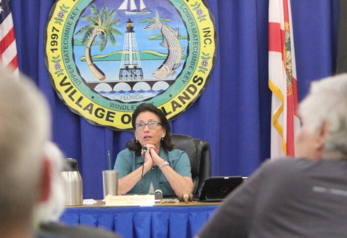 Mayor Sharon Mahoney a woman sitting at a table in front of a microphone
