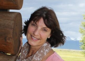 a woman standing next to a wooden structure