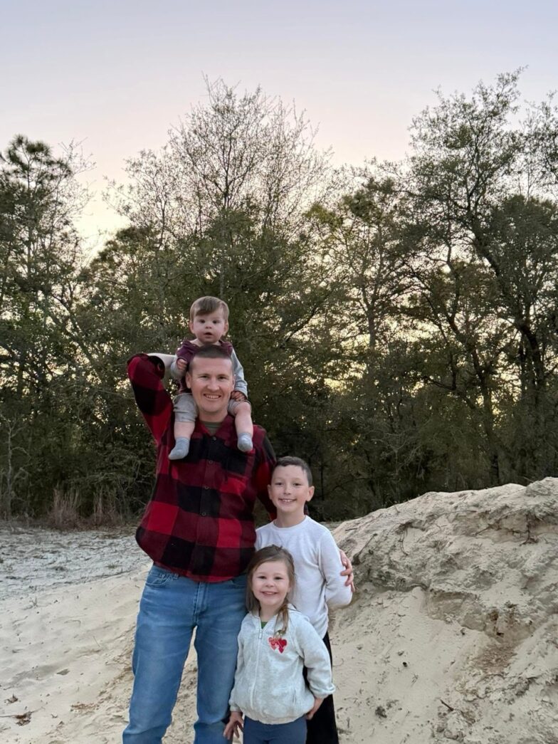a family poses for a picture on the beach