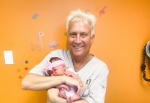 a man holding a baby in his arms