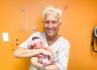 a man holding a baby in his arms