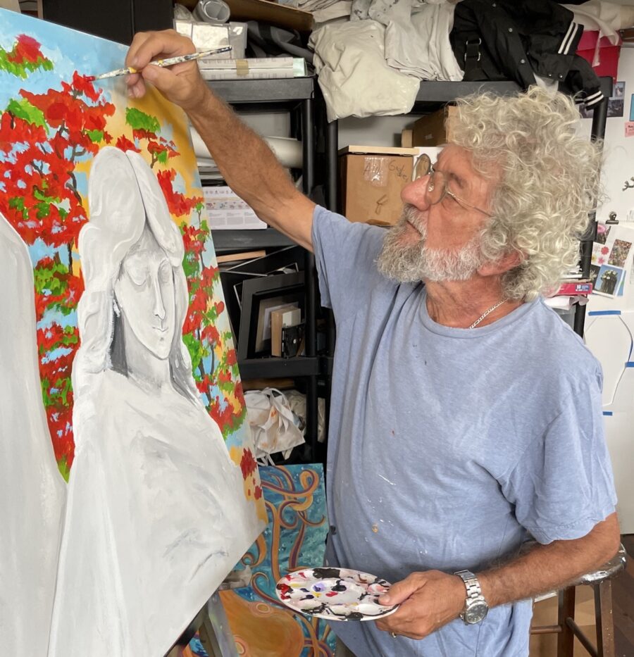 a man painting a picture of a woman on a canvas