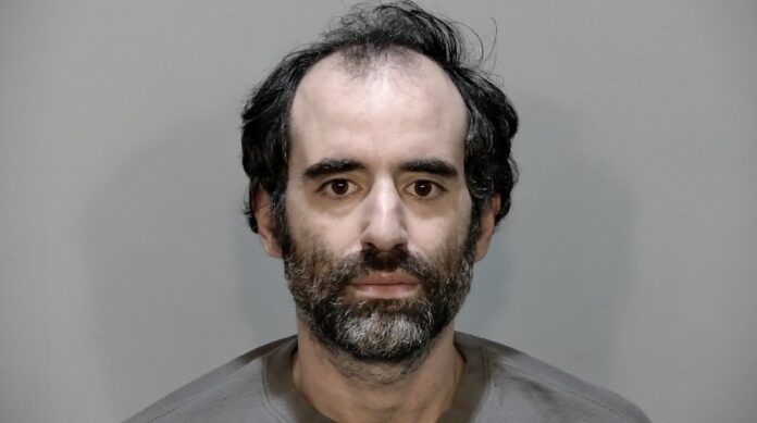 a mug shot of a man with a beard