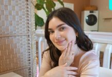 a woman sitting at a table with her hand on her face