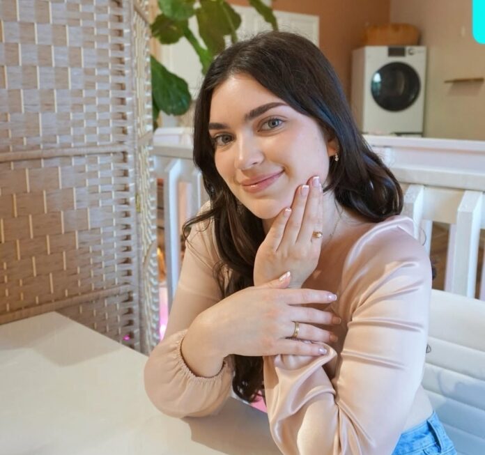 a woman sitting at a table with her hand on her face