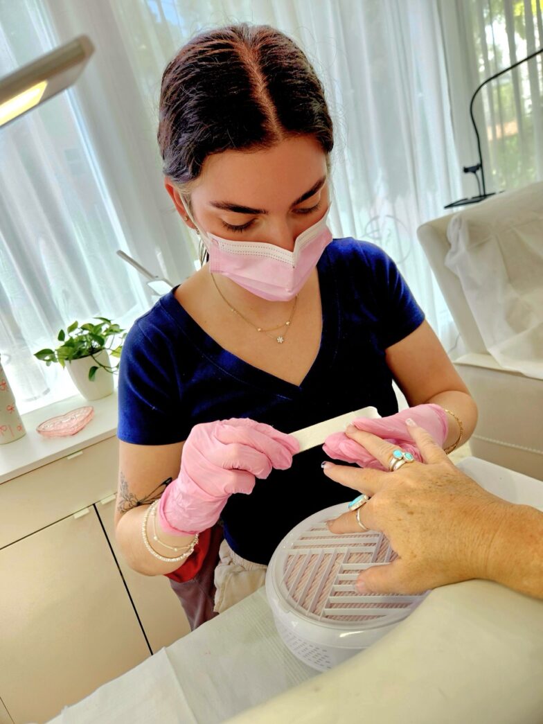 a woman getting her teeth brushed by a dentist