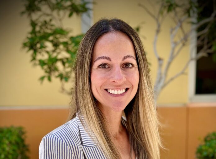 cathy crane headshot a woman in a suit smiling for the camera
