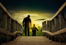 a man and a child walking across a bridge