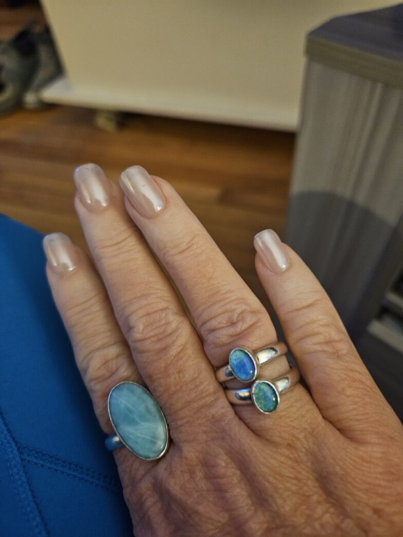 a woman's hand with two rings on it