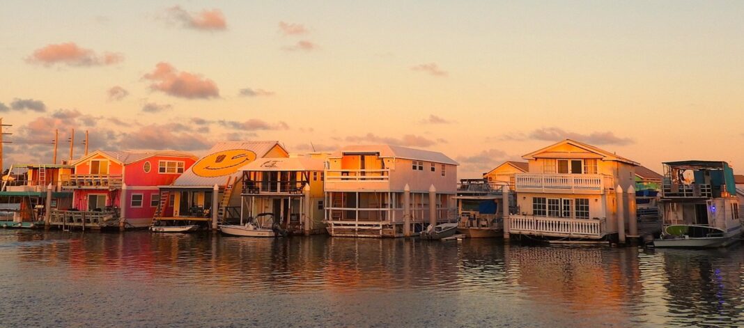 a row of houses sitting on top of a body of water