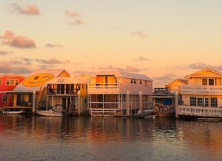 a row of houses sitting on top of a body of water