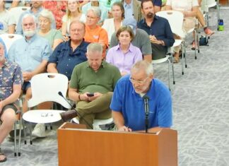 a group of people sitting in chairs in a room
