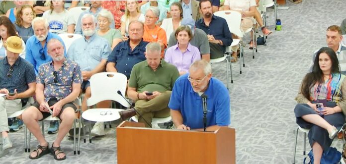 a group of people sitting in chairs in a room