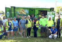 a group of people standing in front of a food truck