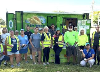 a group of people standing in front of a food truck