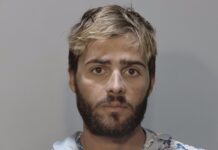a mug shot of a man with blonde hair