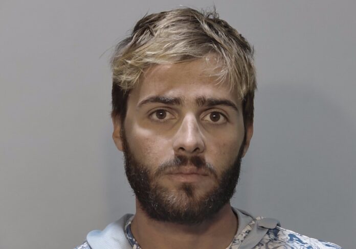 a mug shot of a man with blonde hair