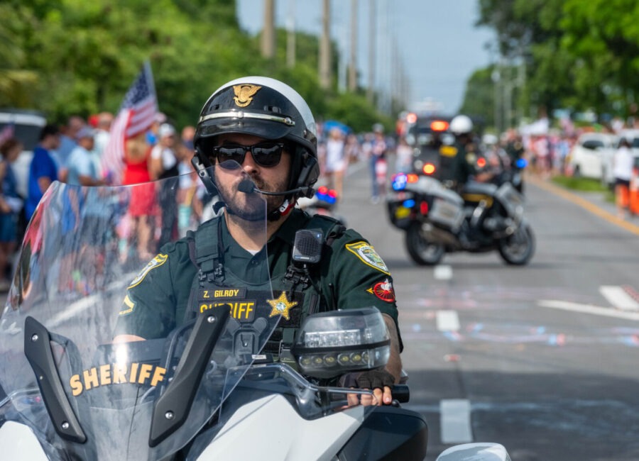 a police officer riding a motorcycle down a street