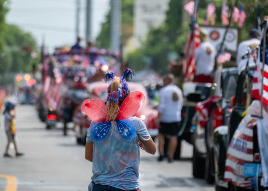 a woman walking down the street in a parade