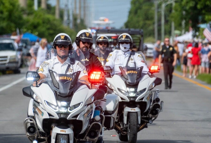 a group of police officers riding motorcycles down a street