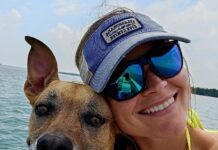 a woman and her dog are on a boat
